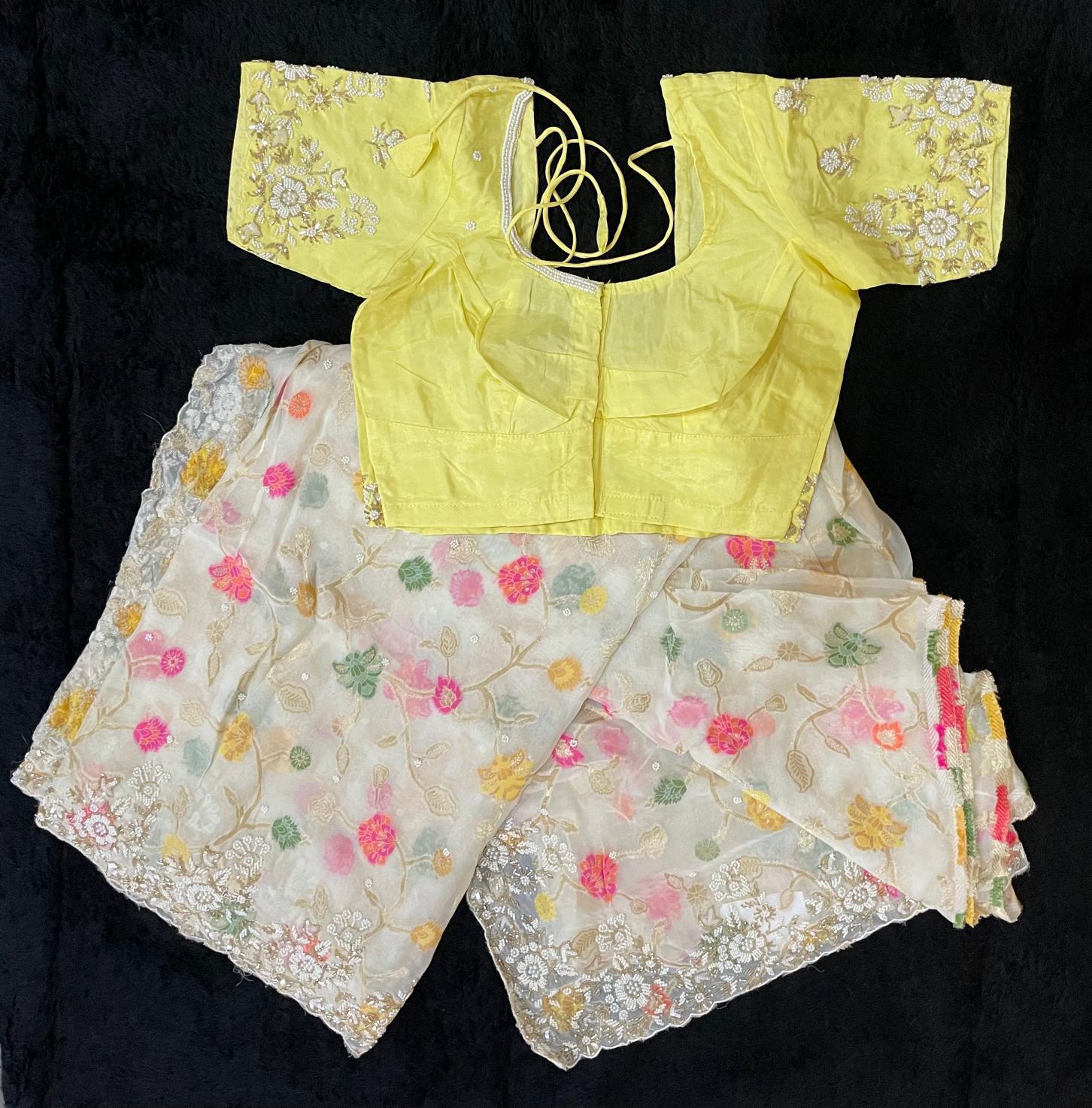 Premium Banarasi Fancy Saree in cream color with a rich embroidered light yellow blouse