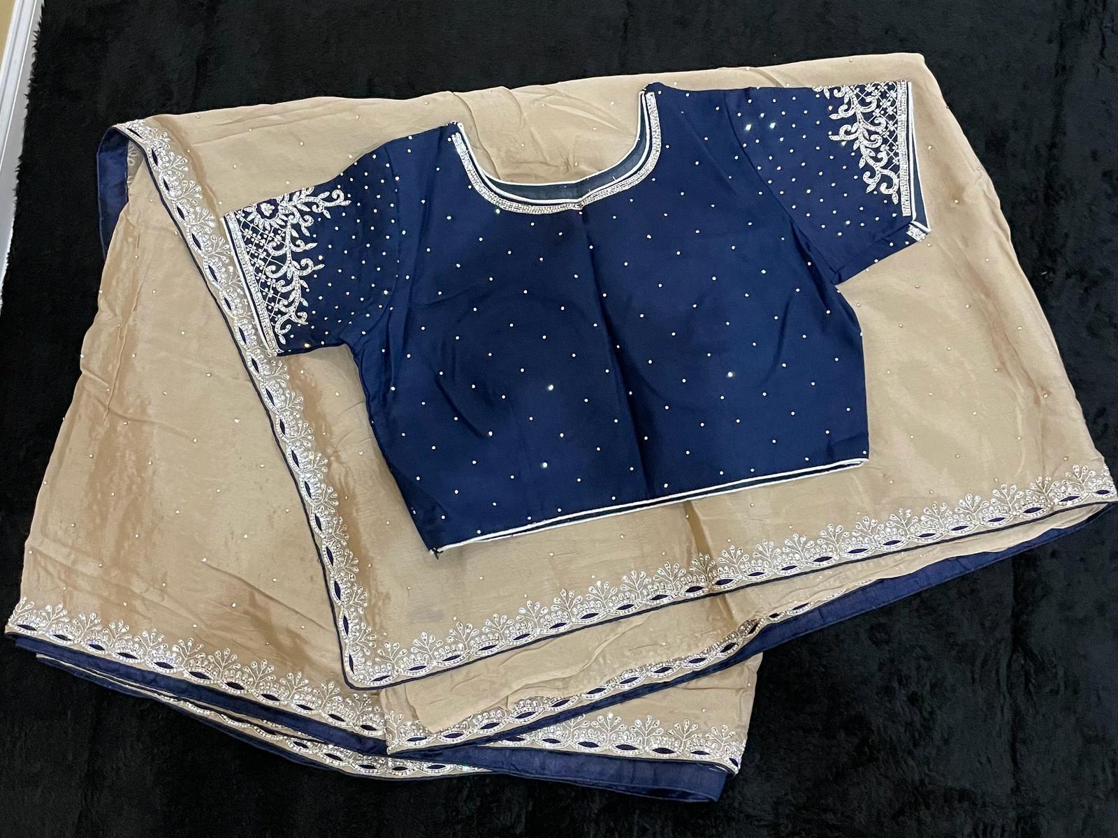 Premium Fancy Saree in beige color with dark navy blouse with swarovski stone work in both saree and blouse