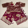 Fancy Saree in dark maroon color with all over zari brocade work and ready-to-wear brocade blouse