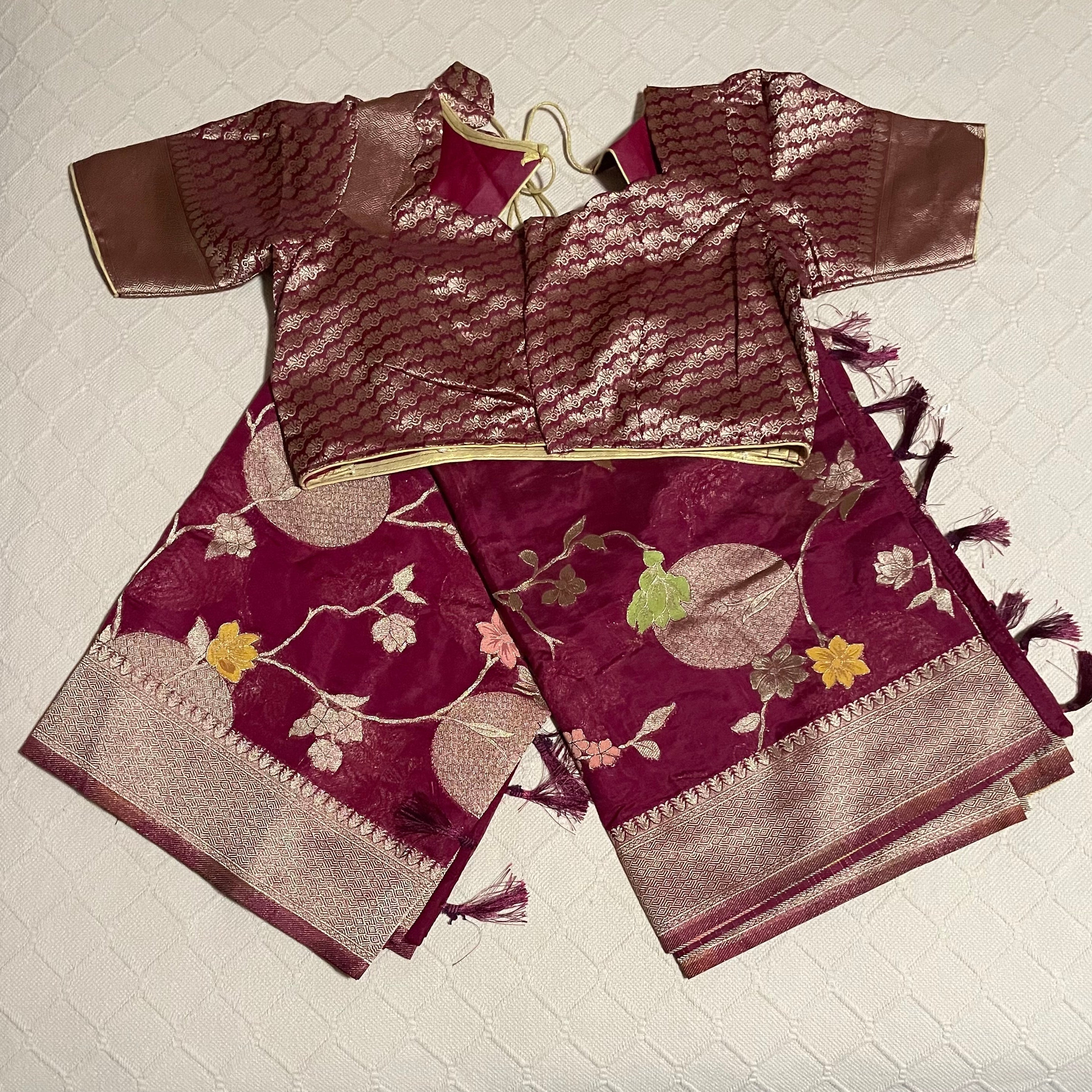 Fancy Saree in dark maroon color with all over zari brocade work and ready-to-wear brocade blouse